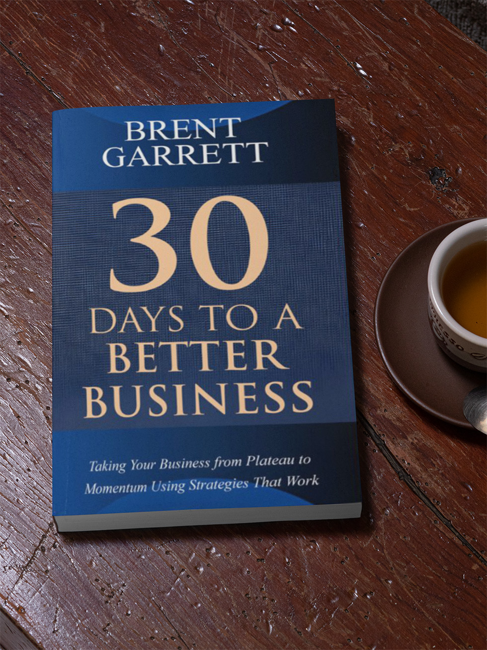 mockup of a paperback book placed on a wooden table 30 days to a better business